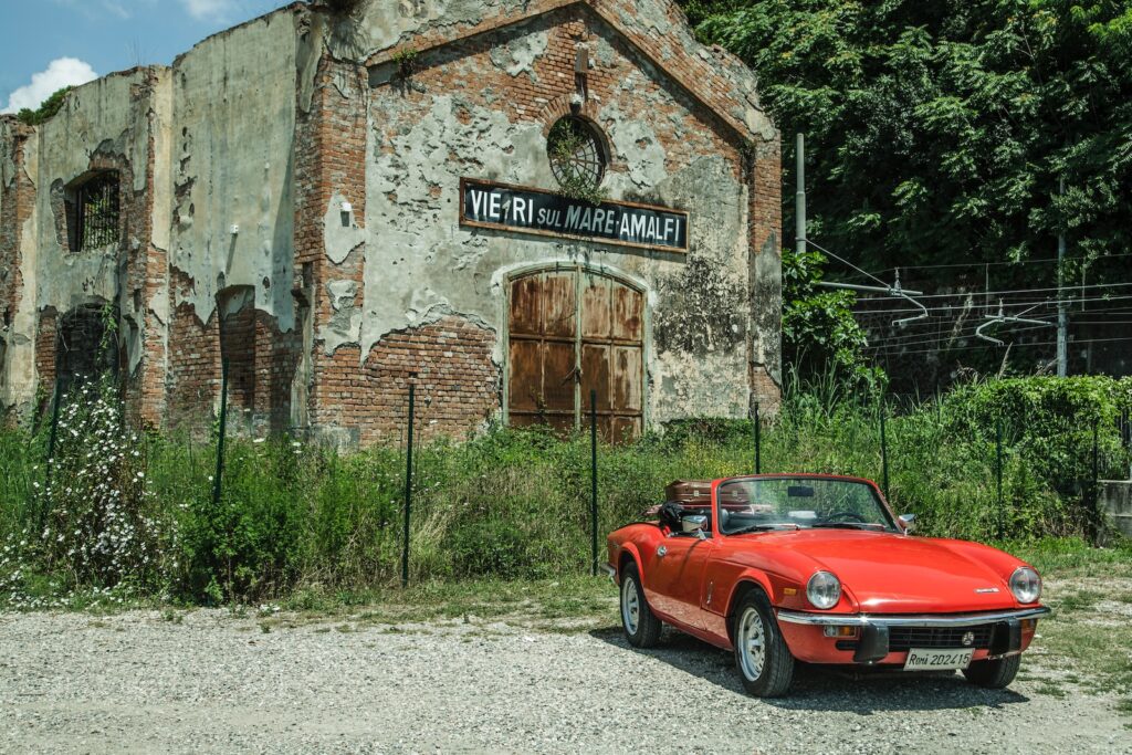 a red car parked in front of an old building